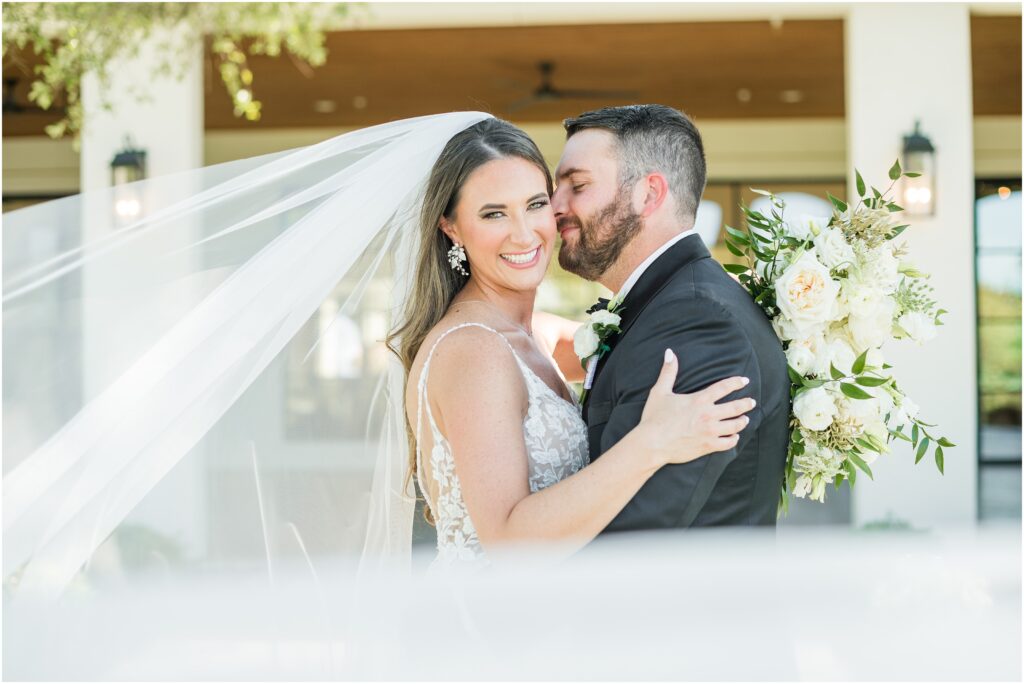 Bride and groom with sweeping veil at their Jacksonville Fl wedding