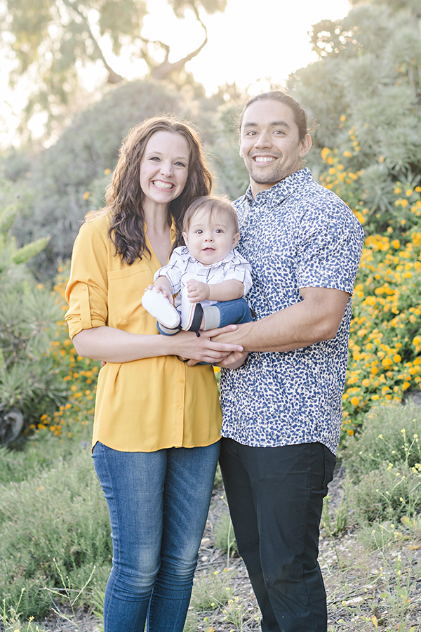 Family Portrait with mom dad and baby with yellow flowers