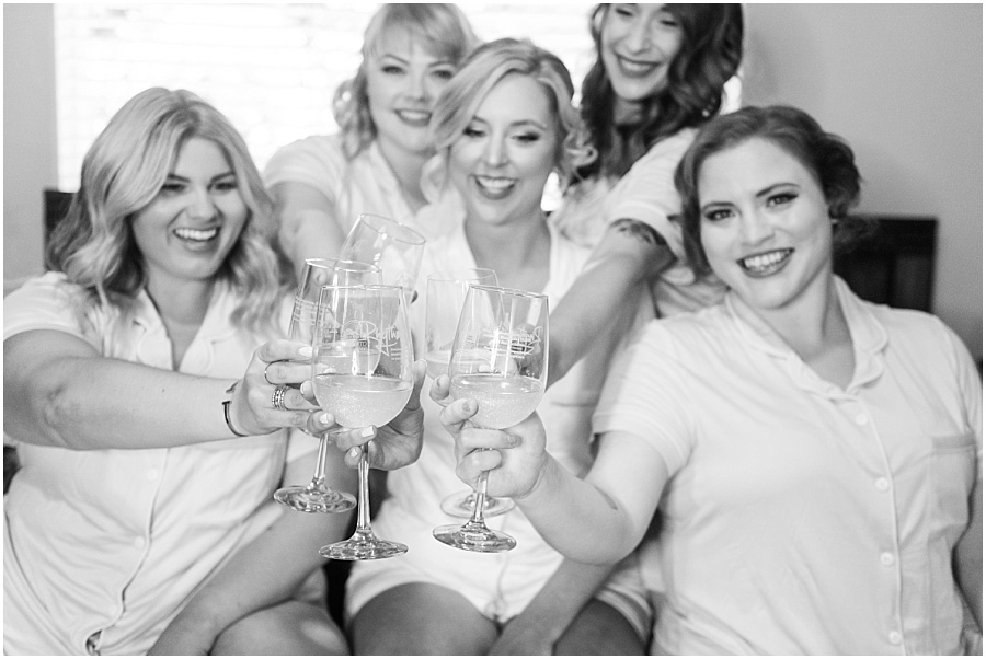Bride getting ready with bridesmaids toasts