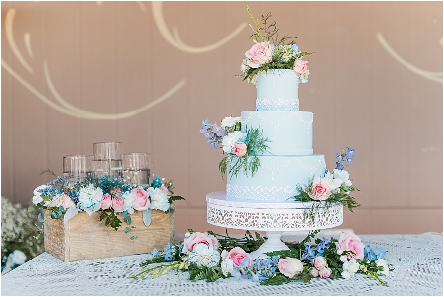 Light blue wedding cake with pink and blue flowers