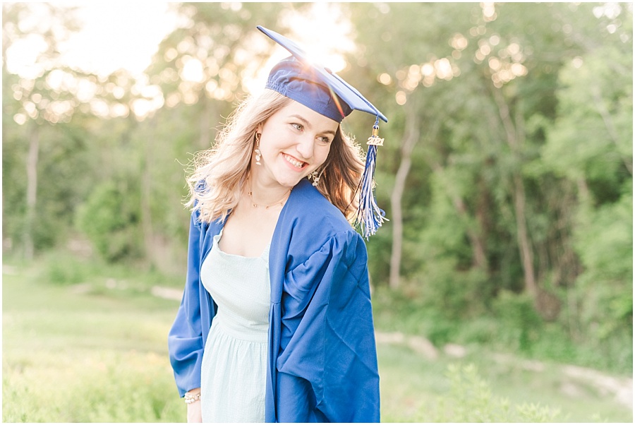 Houston senior session in the wildflowers on the Terry Hershey Trail in cap and gown