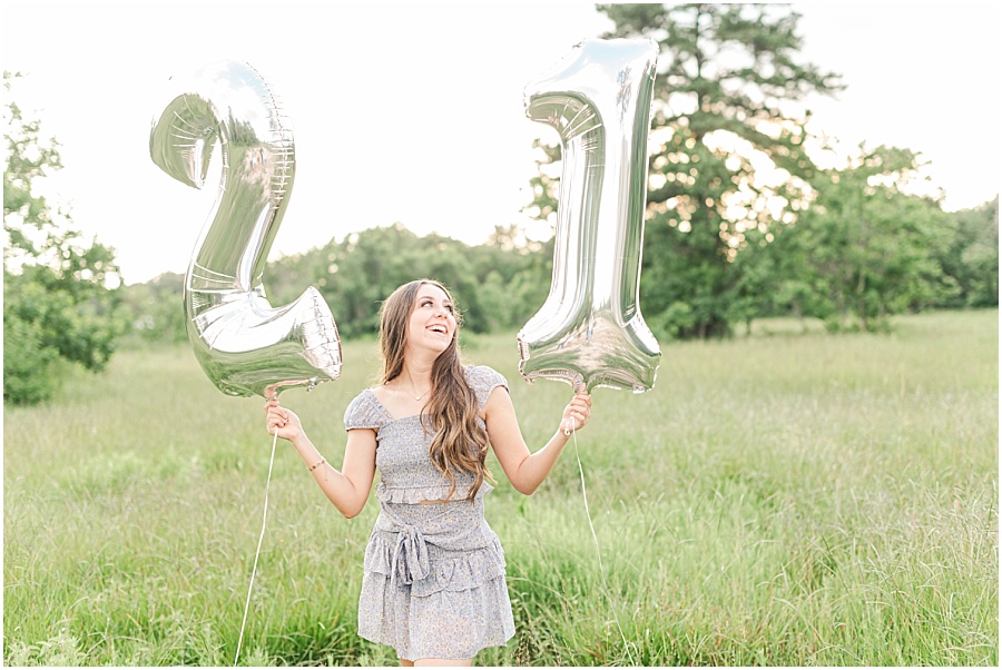 Cypress Texas senior photography in a field with mylar number balloons