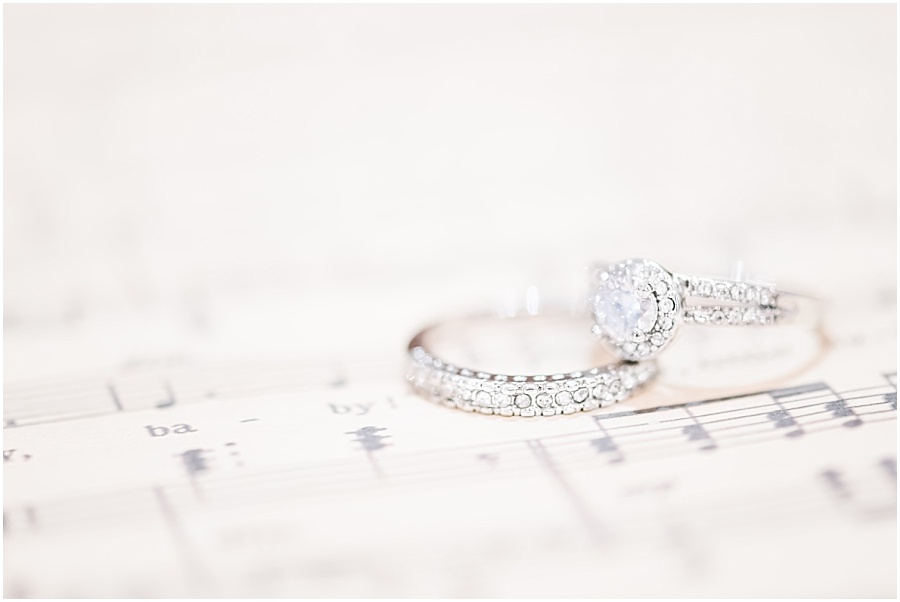 Wedding ring detail photo with sheet music