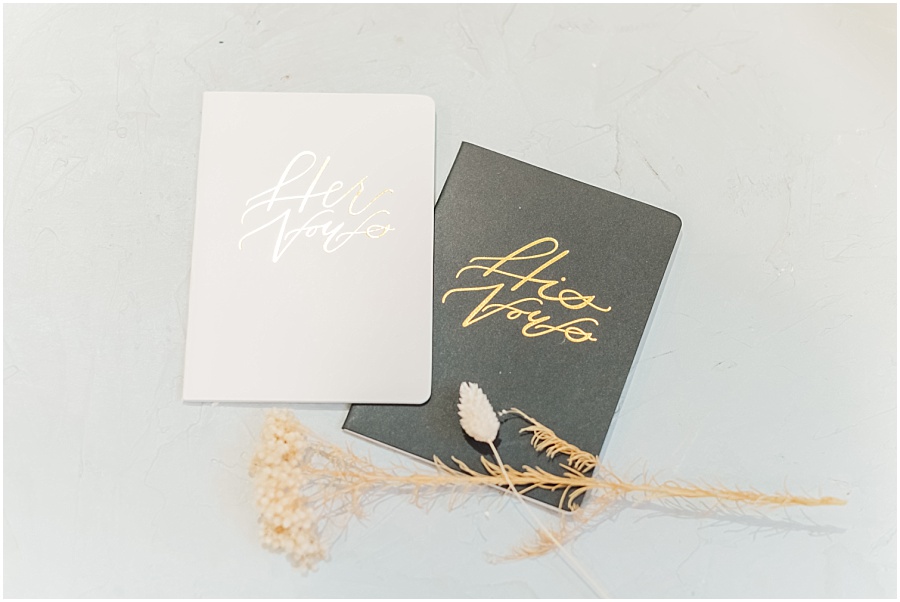 White and black vow books for wedding ceremony at the Springs Wedding Venue Cyypress