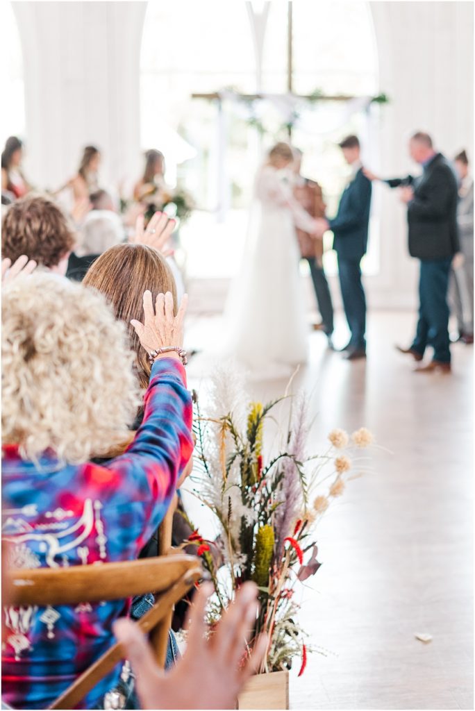 Blessing the couple during an Indoor wedding ceremony at The Springs Wallisville.