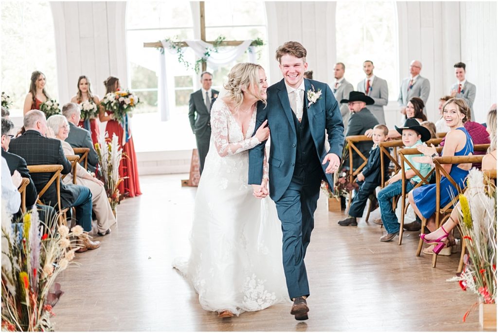 Bride and groom recessional during an Indoor wedding ceremony at The Springs Wallisville.