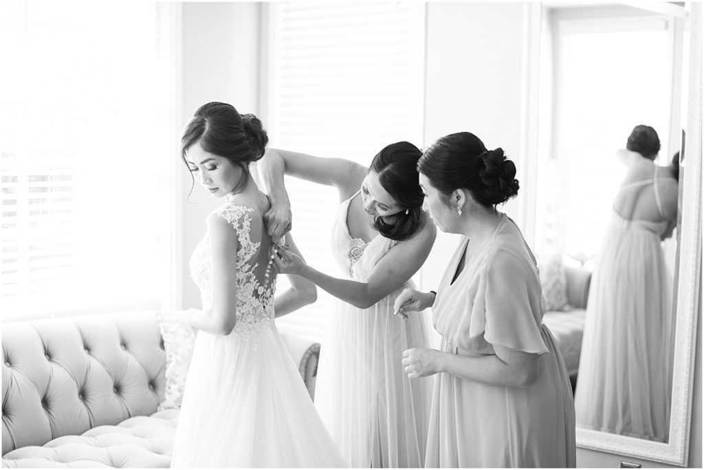 Bride getting ready in a light and airy bridal suite