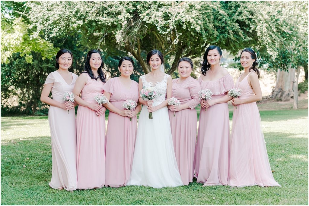 Bridesmaids Pictures with light pink dresses and pink carnation and baby's breath bouquets