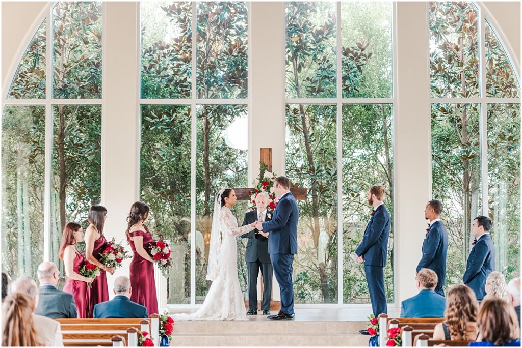 Wedding ceremony at Ashton Gardens West with red floral details