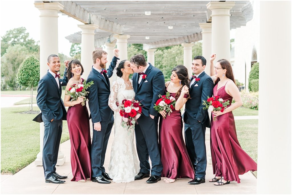 Wedding Party pictures at Ashton Gardens West with red floral details. Maroon bridesmaids dresses.Bridesmaids dress