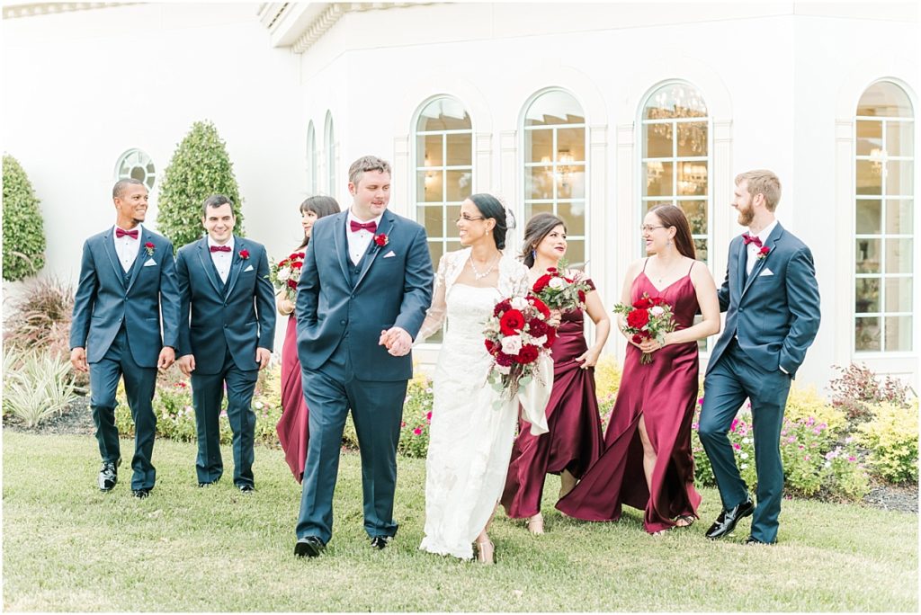 Wedding Party pictures at Ashton Gardens West with red floral details. Maroon bridesmaids dresses.Bridesmaids dress