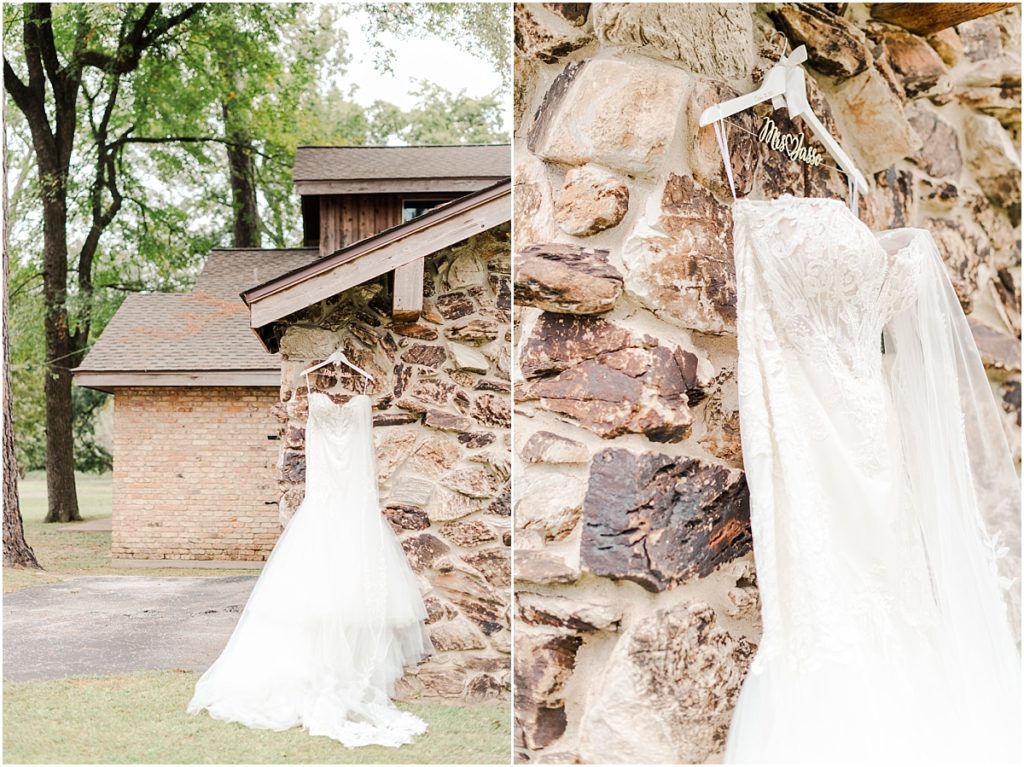 Wedding dress handing on brown rock wall at Shirley Acres