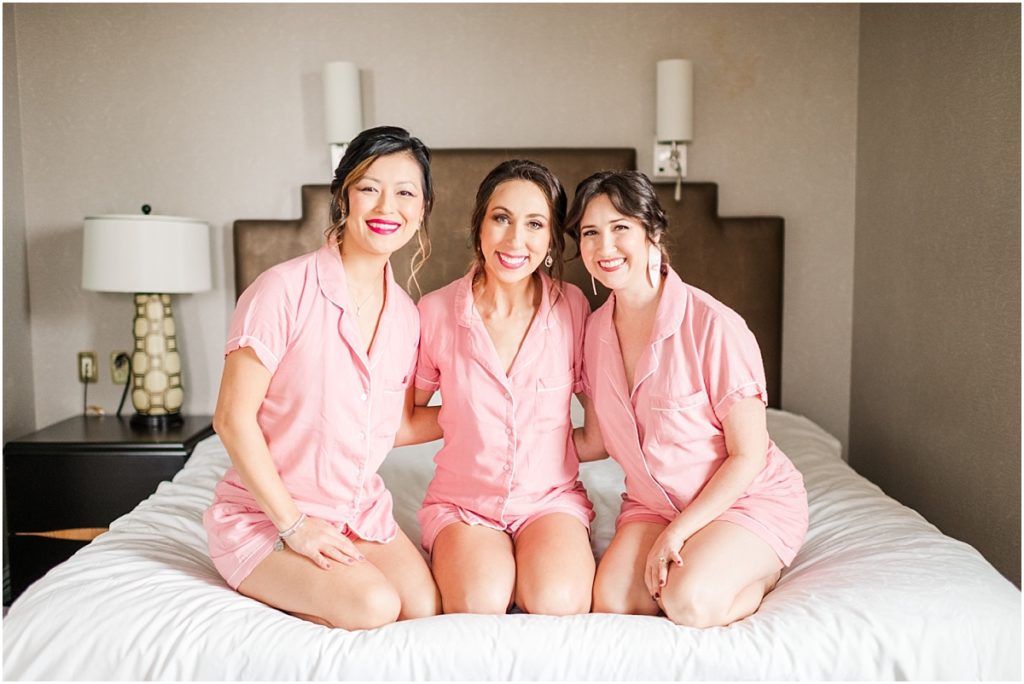 Bride getting ready with bridesmaids in pink pajamas at the Icon Hotel in Houston