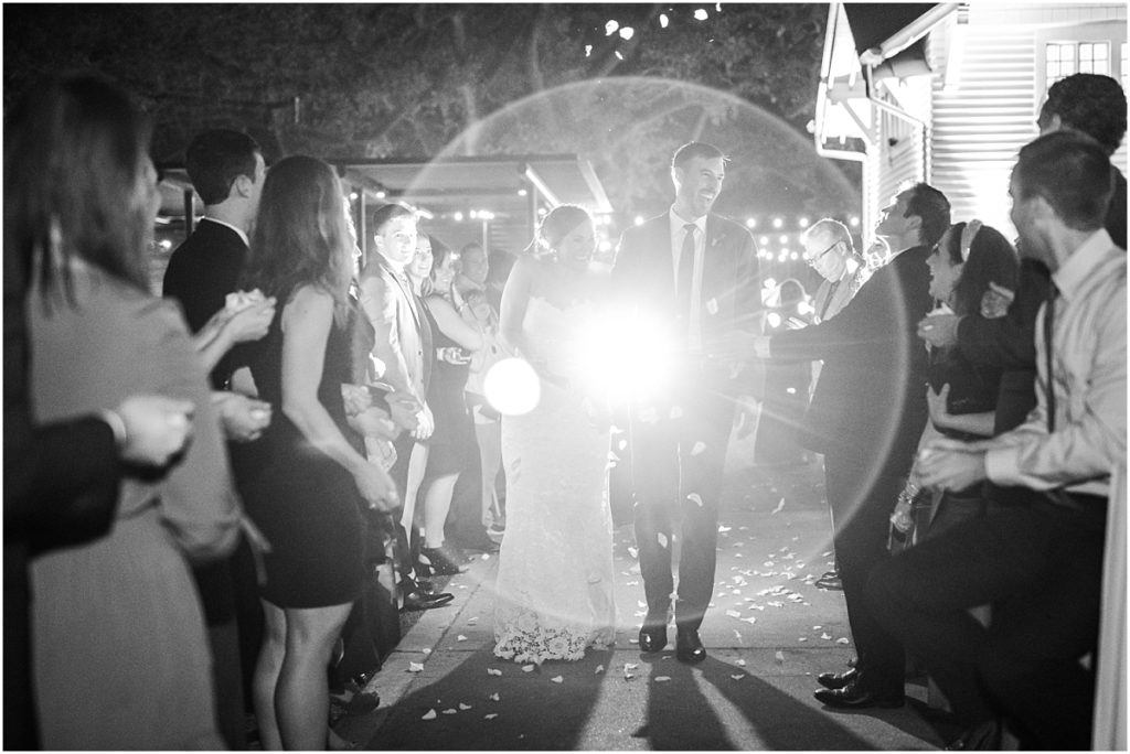Bride and groom's grand exit with flower petals at Evelyn's Park in Houston Texas