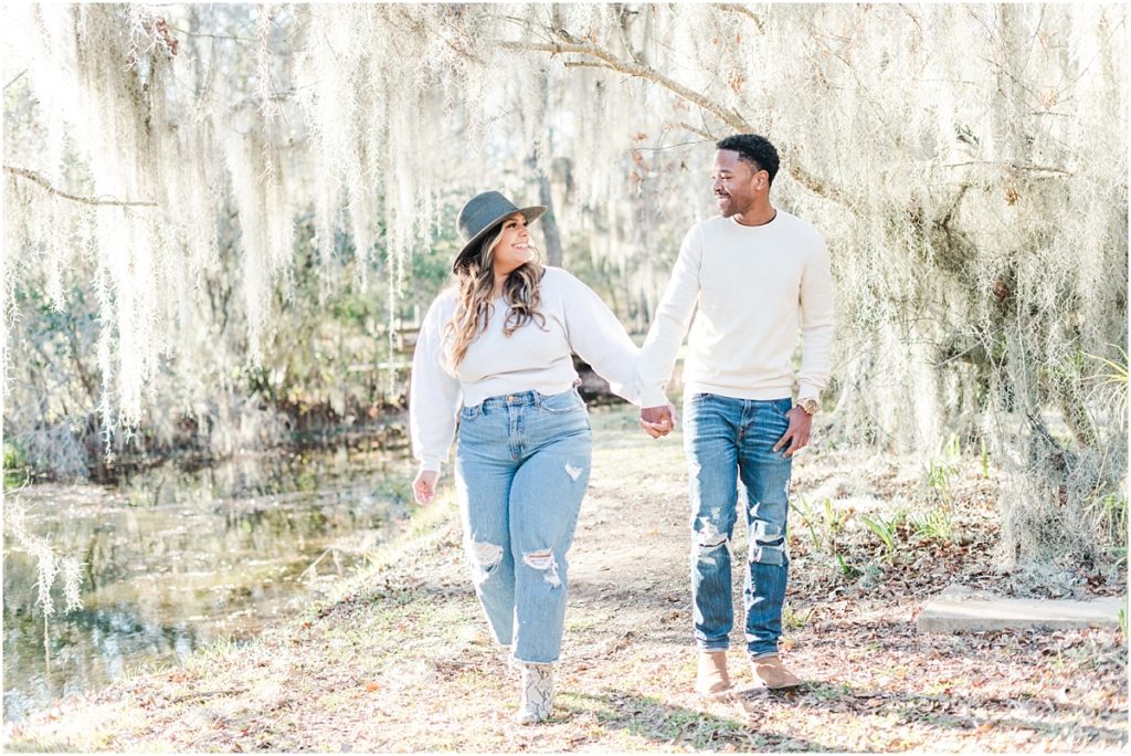 Walking through spanish moss at a Cypress Engagement Session