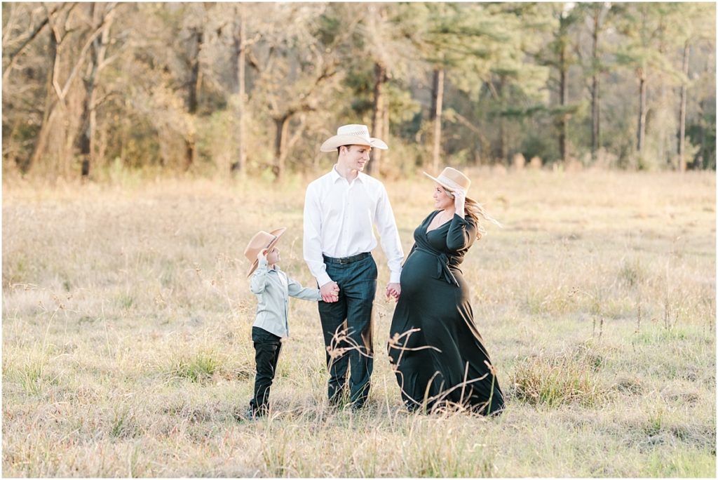 Maternity Session in a field with cowboy hats