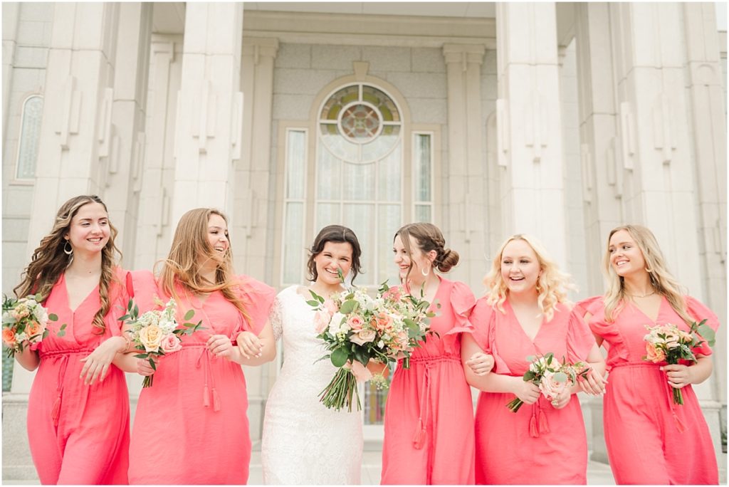Bridesmaids in coral dresses at the Houston Temple
