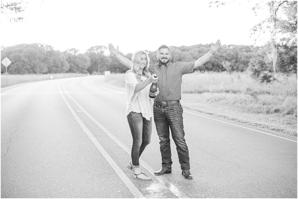 Popping chamgpagne at engagement session at Brazos Bend State Park