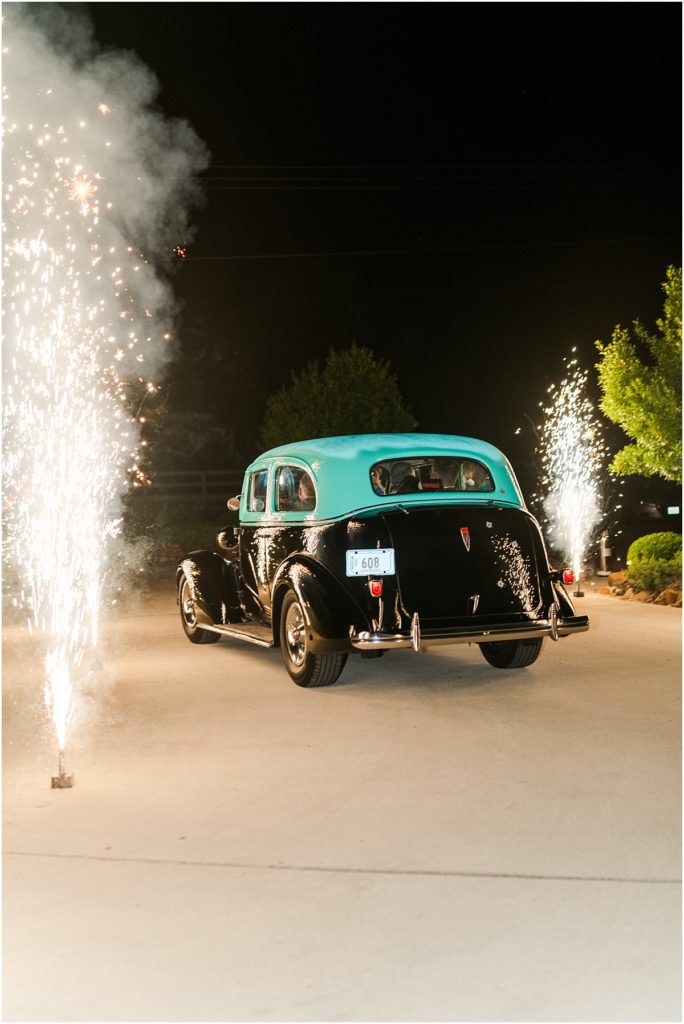 Vintage getaway car with cold sparks up the driveway at The Farmhouse