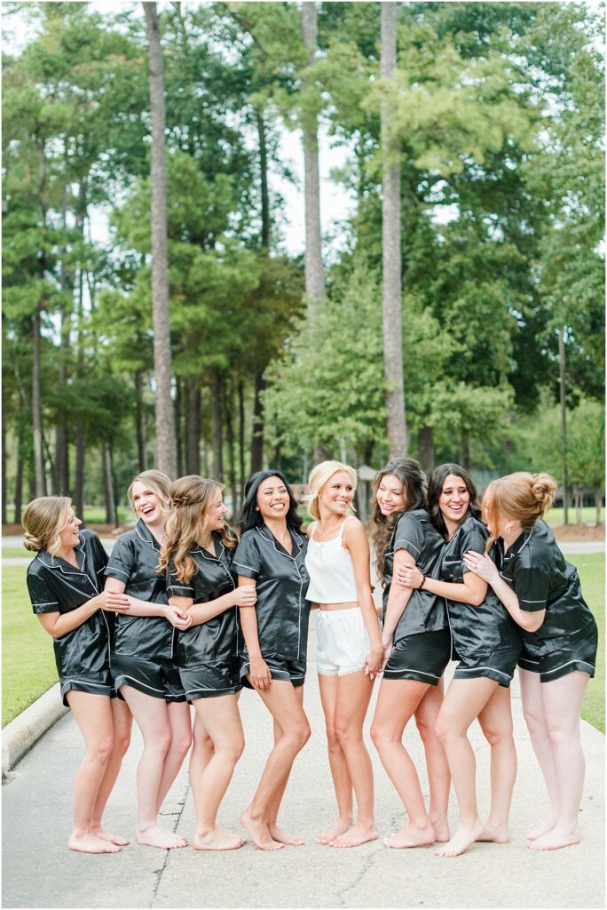 Bridesmaids getting ready in their black jammies at a wedding at the Woodlands Country Club