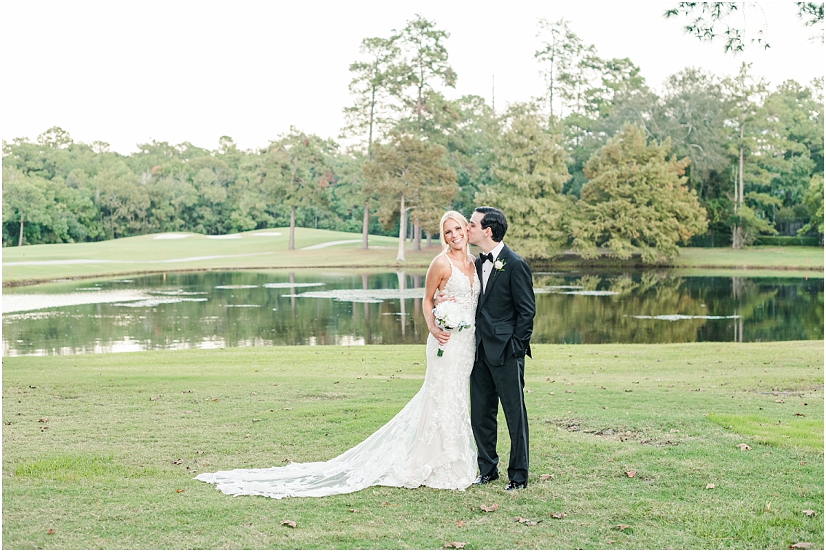 The Woodlands wedding photography of bride and groom after wedding on golf course by the lake.