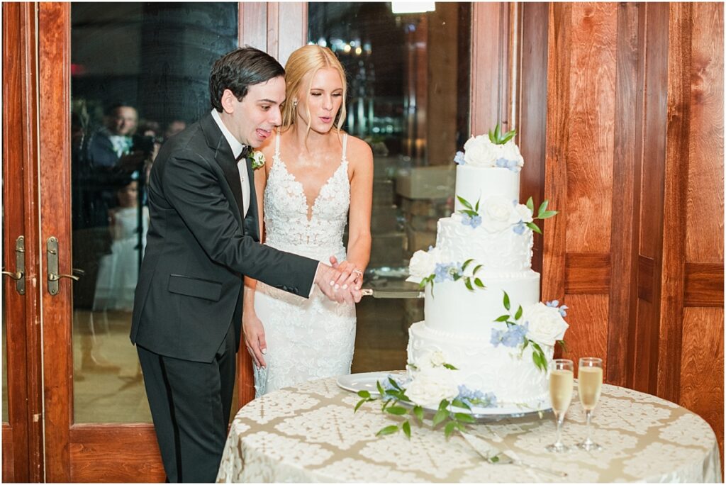 Cutting a beautiful wedding cake at a Houston country club wedding reception