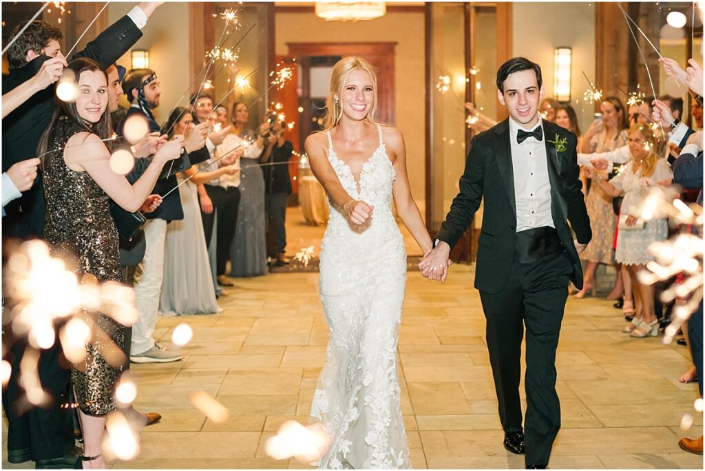 A bride and grooms grand exit from their wedding reception in Houston at The Woodlands Country Club