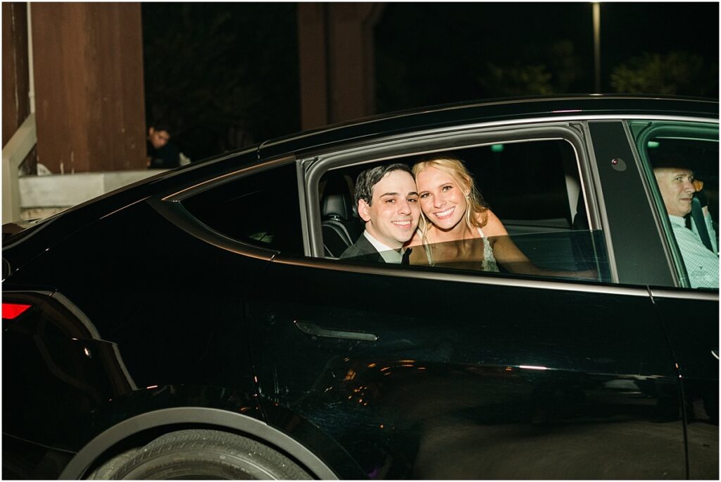 A bride and grooms grand exit from their wedding reception in Houston at The Woodlands Country Club