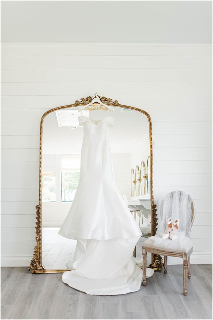 Wedding dress hanging on the mirror at Boxwood Manor in Houston Texas.