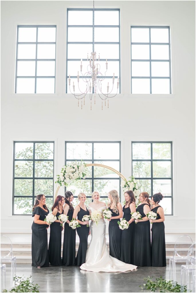 Bridesmaids in black dresses with and white flowers at Boxwood Manor.