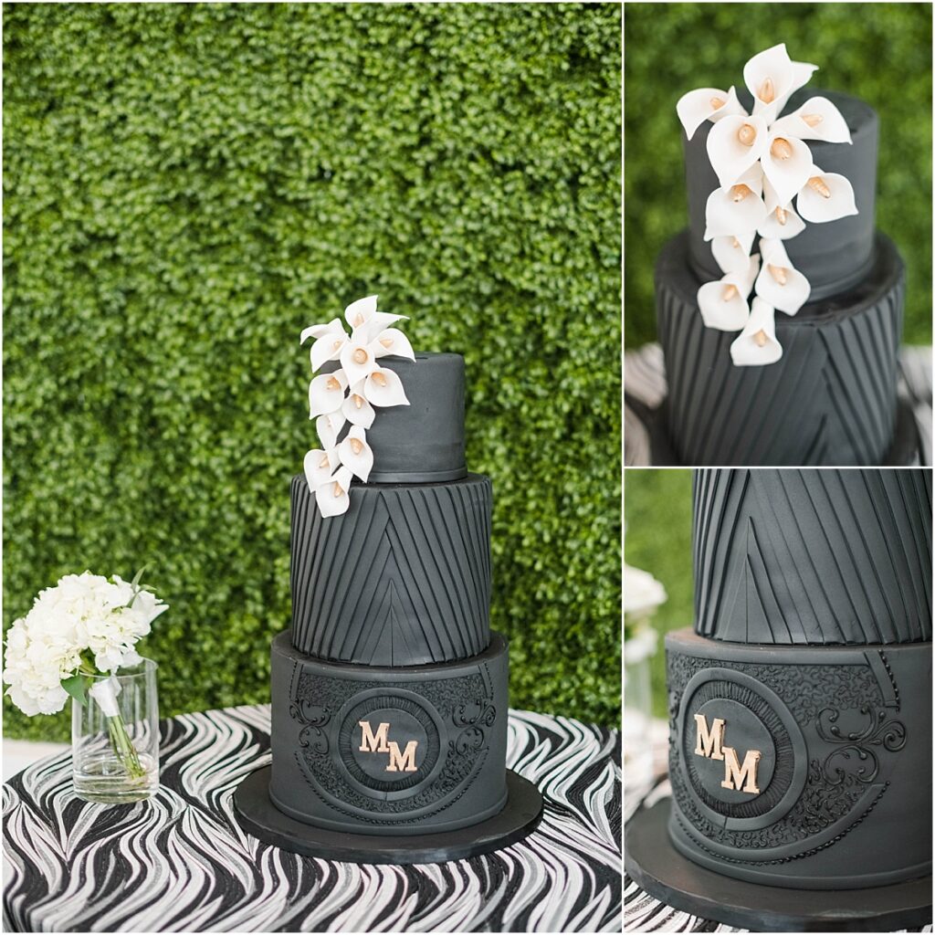 Black cake with gold monogram and white lillies.