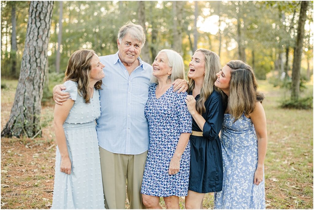 Daughters laughing at their dad during family pictures in a St. Augustine Park.