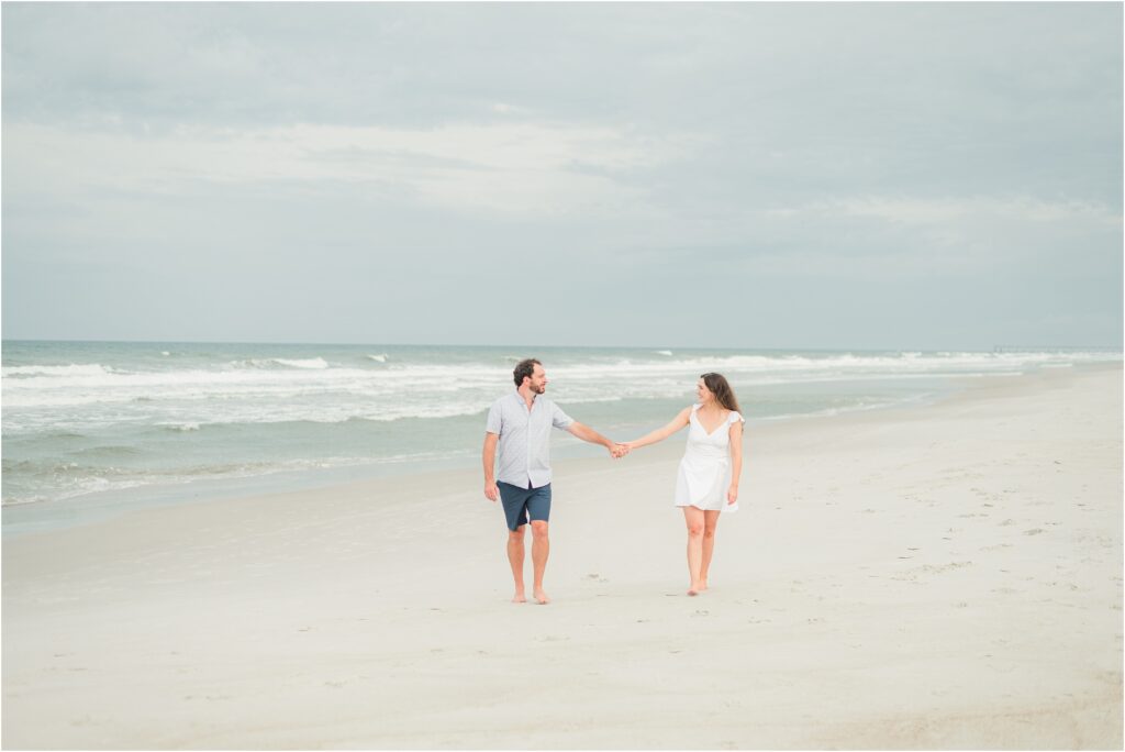 Walking holding hands on the beach in Neptune beach