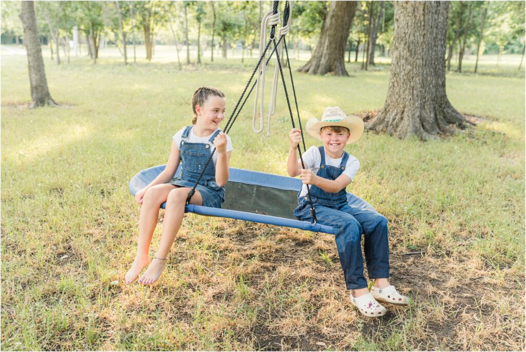 Kids swinging on the farm during their family photo session in College Station