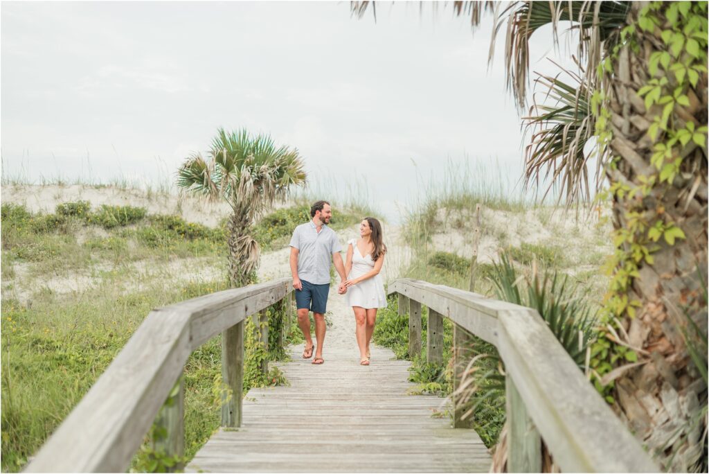Walking to the beach during their Jacksonville engagement session at the beach.