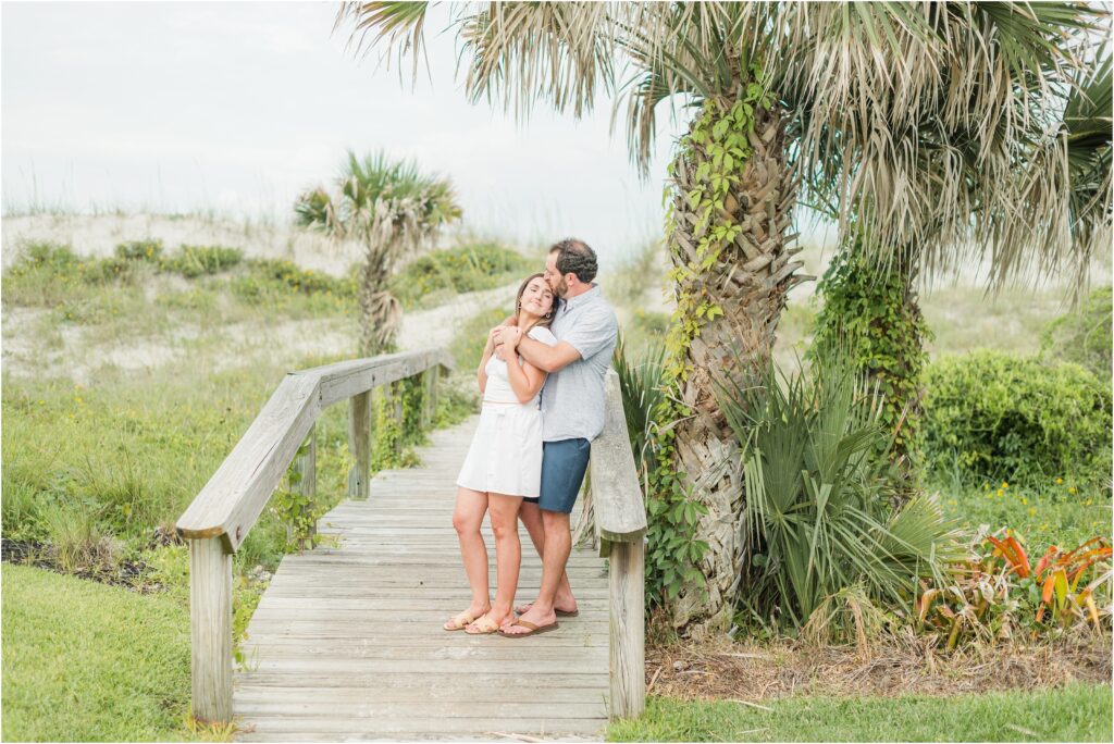 Engagement session on the wooden walkway to the beach at Neptune beach