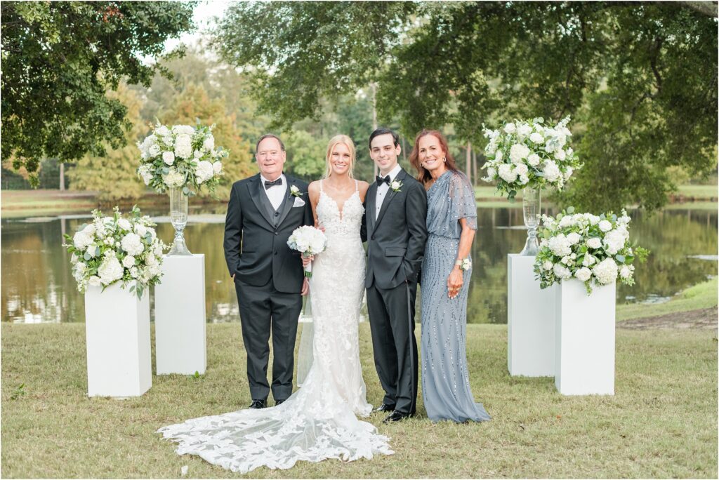 Formal family photos by a lake at a St. Augustine country club wedding
