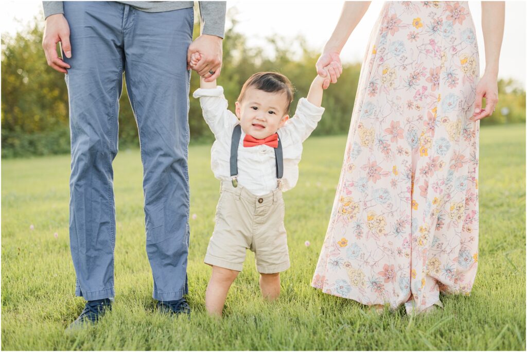 Little boy holding mom and dad's hands at Jacksonville Florida family portrait session